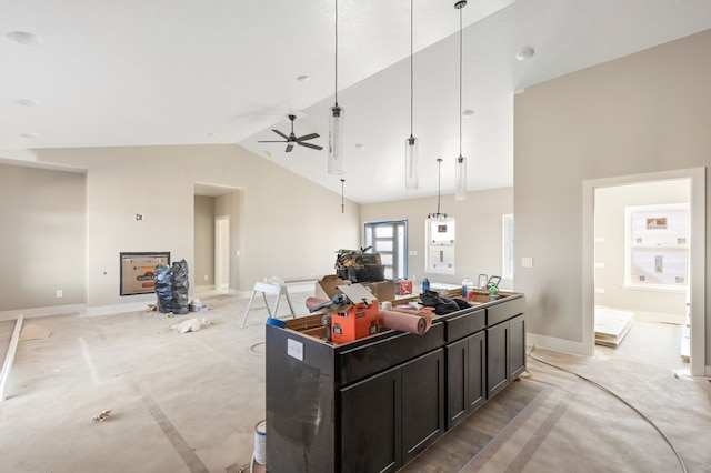 kitchen featuring high vaulted ceiling, baseboards, a kitchen island, and open floor plan