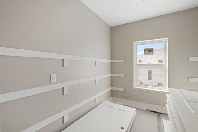 laundry area featuring baseboards