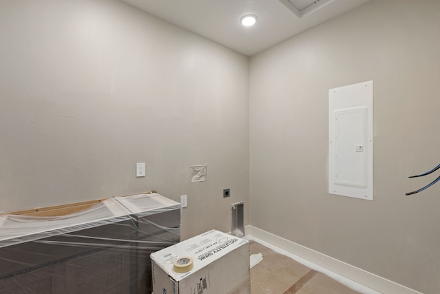 laundry area featuring electric panel, baseboards, laundry area, and hookup for an electric dryer