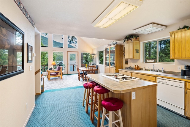 404 Halo Dr, Troy, MT 59935 - kitchen featuring carpet, a kitchen island, a sink, and white appliances