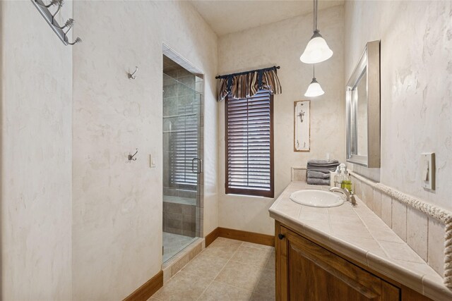 231 Arrowhead Dr, Whitefish, MT 59937 - full bathroom with a shower stall, vanity, baseboards, and tile patterned floors