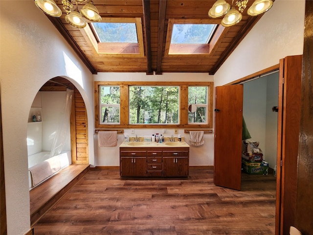 full bathroom with wood ceiling, wood finished floors, a sink, and double vanity