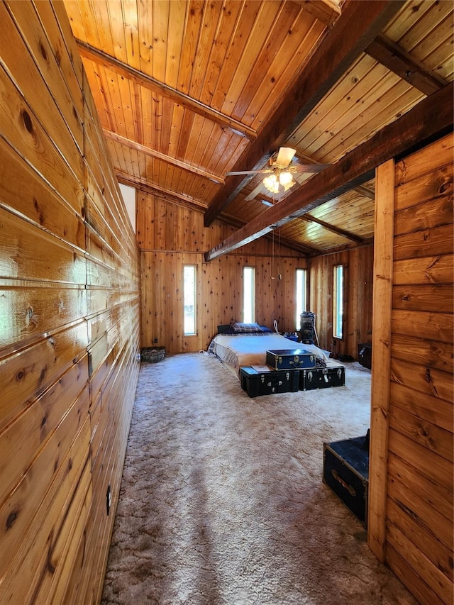 bedroom featuring carpet, wood walls, wood ceiling, and lofted ceiling with beams