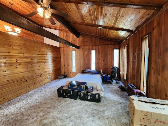 bedroom featuring vaulted ceiling with beams, wooden walls, and multiple windows