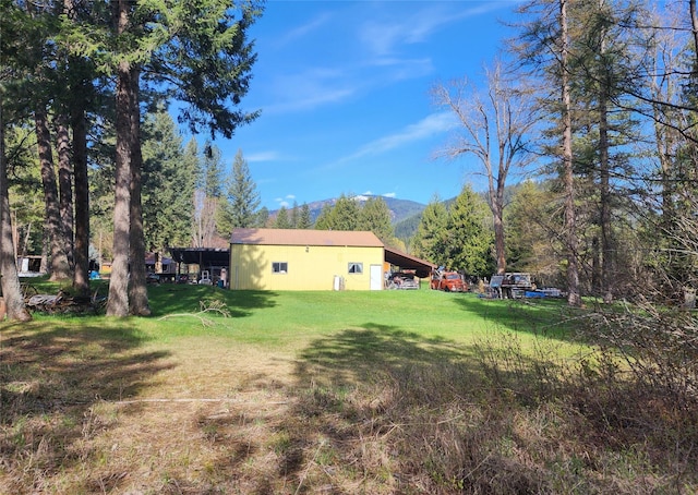 view of yard featuring an outbuilding and a mountain view