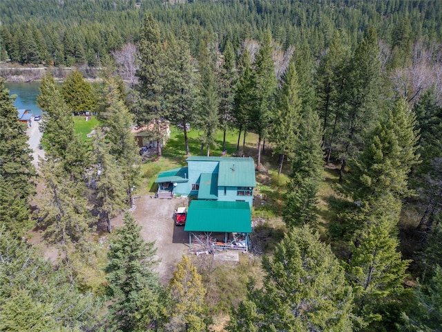 aerial view featuring a view of trees and a water view