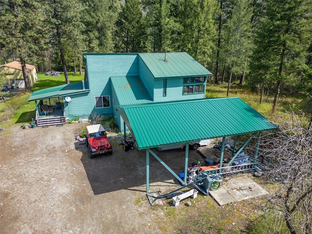 view of outbuilding featuring a view of trees