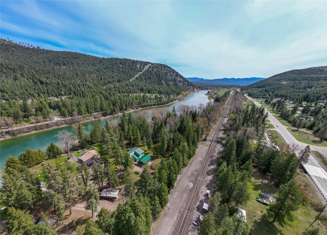 aerial view featuring a water and mountain view and a forest view