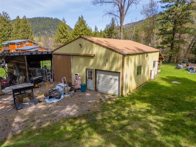 garage with a forest view and driveway