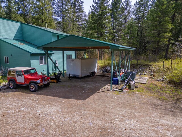 view of parking / parking lot featuring driveway and a carport