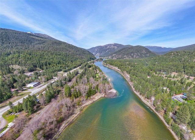 bird's eye view with a forest view and a water and mountain view
