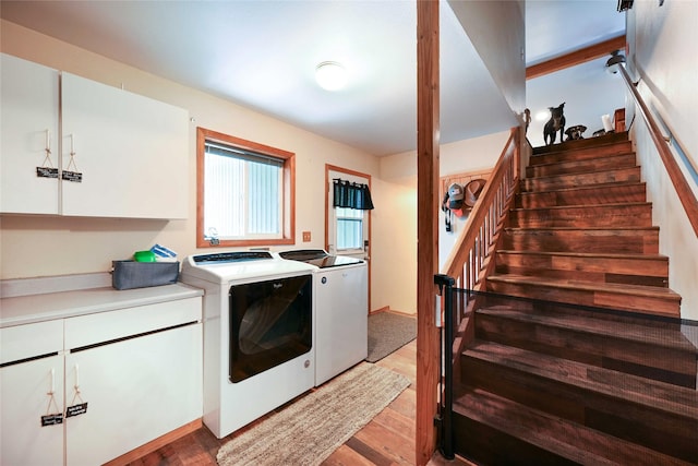 57 Fir St, Trout Creek, MT 59874 - washroom with washing machine and clothes dryer, wood finished floors, and cabinet space
