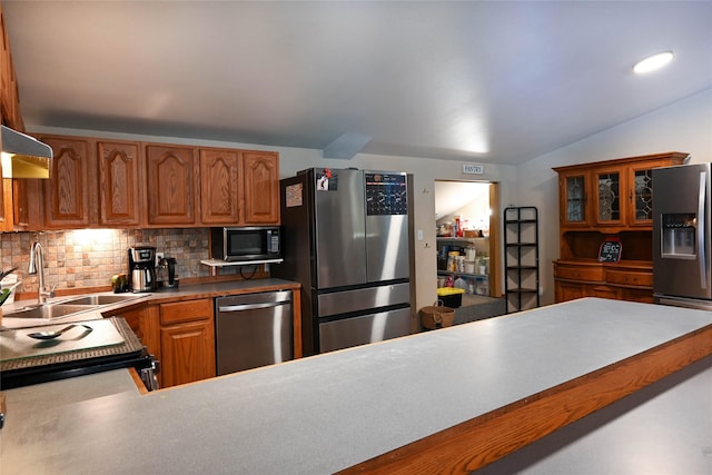 57 Fir St, Trout Creek, MT 59874 - kitchen with stainless steel appliances, backsplash, lofted ceiling, a sink, and brown cabinetry