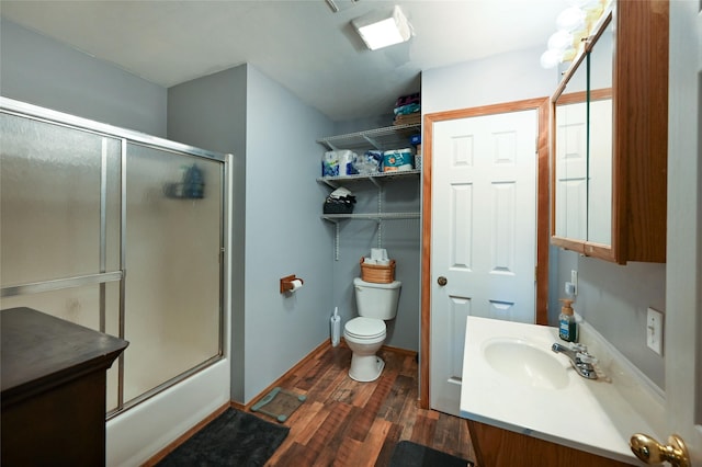 57 Fir St, Trout Creek, MT 59874 - bathroom with wood finished floors, toilet, vanity, and shower / bath combination with glass door