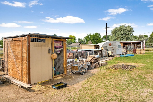 view of poultry coop featuring a lawn
