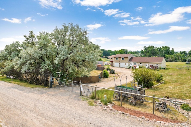 exterior space with a gate, driveway, a garage, and fence