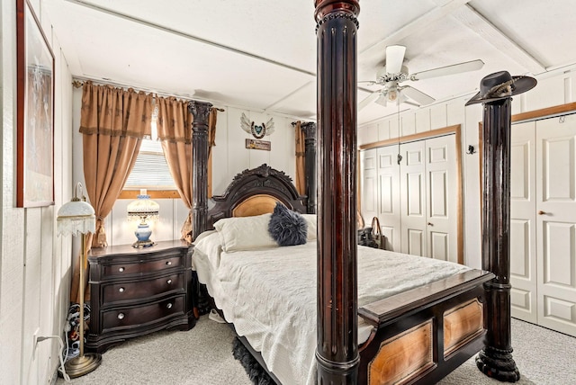 bedroom with ceiling fan, multiple closets, and carpet