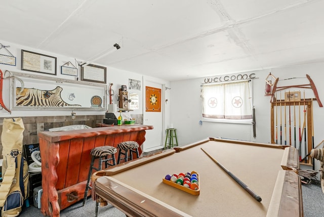rec room featuring a bar and carpet