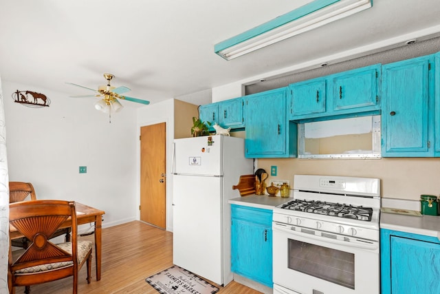 kitchen with blue cabinets, white appliances, and light wood-style flooring
