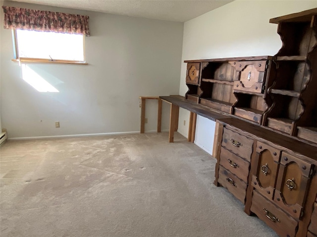 interior space featuring baseboards and light carpet