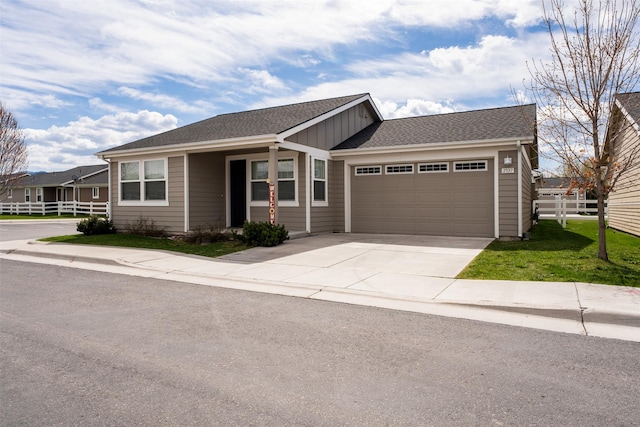 2537 Freedom Loop, Missoula, MT 59808 - ranch-style home featuring fence, concrete driveway, board and batten siding, a front yard, and a garage