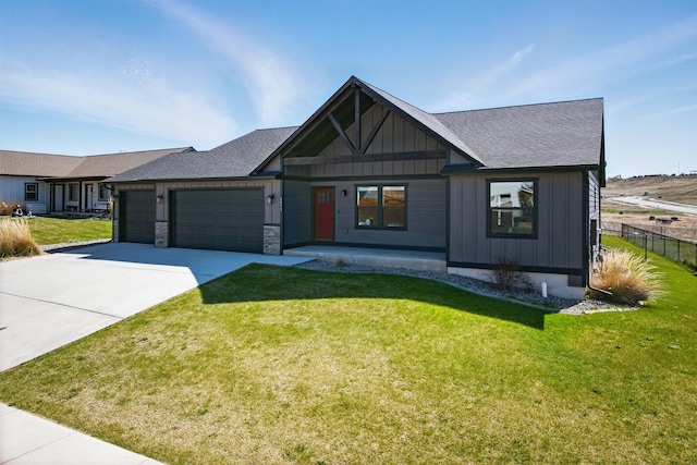 view of front of house featuring driveway, fence, an attached garage, board and batten siding, and a front yard