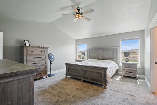 carpeted bedroom featuring lofted ceiling, a ceiling fan, and baseboards
