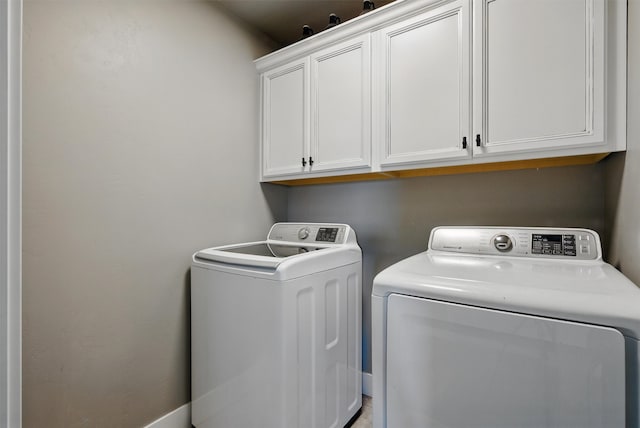 laundry area with washing machine and dryer and cabinet space