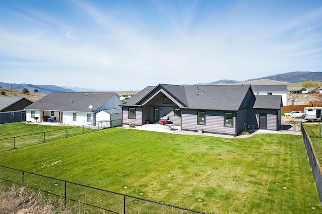 back of house featuring a patio area, a fenced backyard, and a mountain view