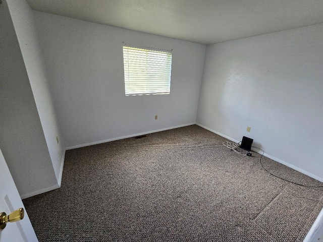spare room with carpet floors and baseboards