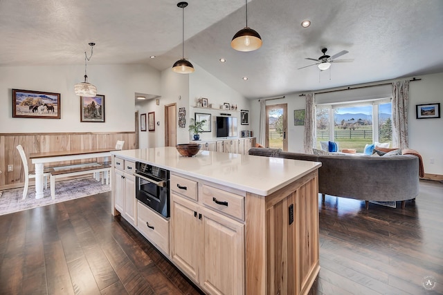 3570 Juniper Dr, Helena, MT 59602 - kitchen with vaulted ceiling, ceiling fan, dark wood-type flooring, a kitchen island, and light countertops