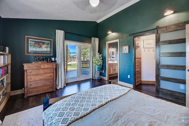 3570 Juniper Dr, Helena, MT 59602 - bedroom with lofted ceiling, access to outside, dark wood-style floors, a barn door, and ensuite bathroom