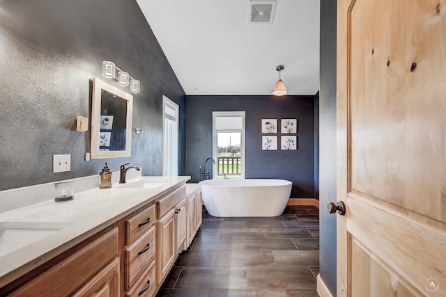 3570 Juniper Dr, Helena, MT 59602 - full bath featuring double vanity, a freestanding bath, and a textured wall