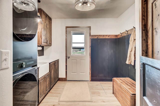 3570 Juniper Dr, Helena, MT 59602 - laundry area with cabinet space, stacked washer / dryer, and light wood-type flooring