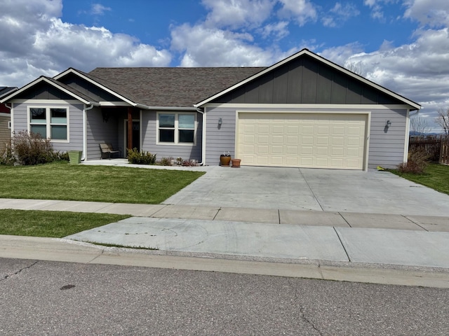 262 Birch Ln, Stevensville, MT 59870 - view of front of home featuring roof with shingles, driveway, an attached garage, board and batten siding, and a front yard