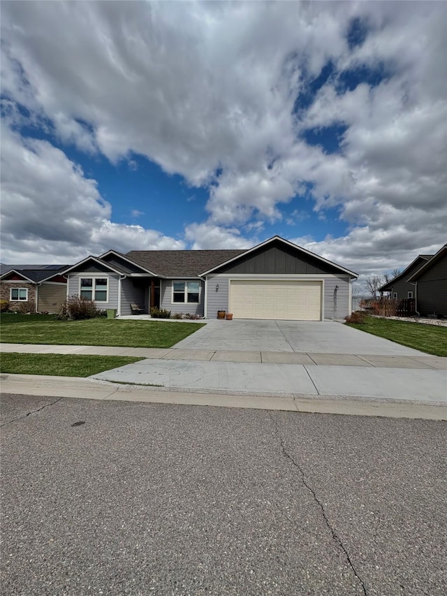 262 Birch Ln, Stevensville, MT 59870 - ranch-style house with a garage, driveway, board and batten siding, and a front lawn