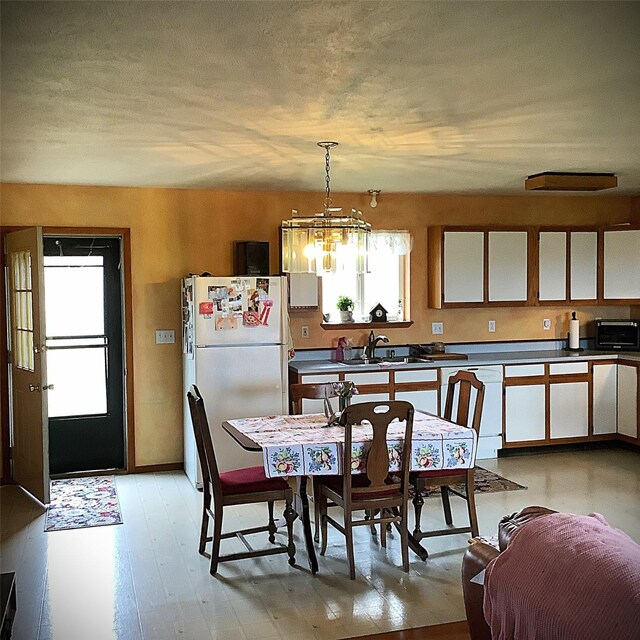 183 Ksanka View Rd, Eureka, MT 59917 - dining area featuring light wood finished floors and a notable chandelier
