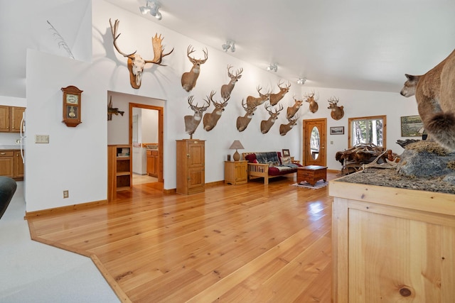 1000 Kelley Rd, Columbia Falls, MT 59912 - kitchen featuring light wood-style floors, open floor plan, vaulted ceiling, and baseboards