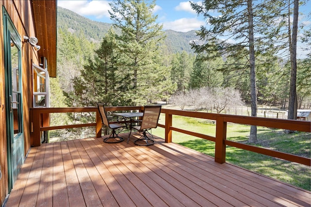 1000 Kelley Rd, Columbia Falls, MT 59912 - deck featuring a mountain view, a wooded view, and outdoor dining space