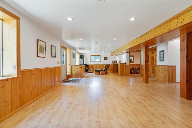 1000 Kelley Rd, Columbia Falls, MT 59912 - unfurnished living room with a wood stove, a wainscoted wall, light wood-style flooring, wood walls, and recessed lighting
