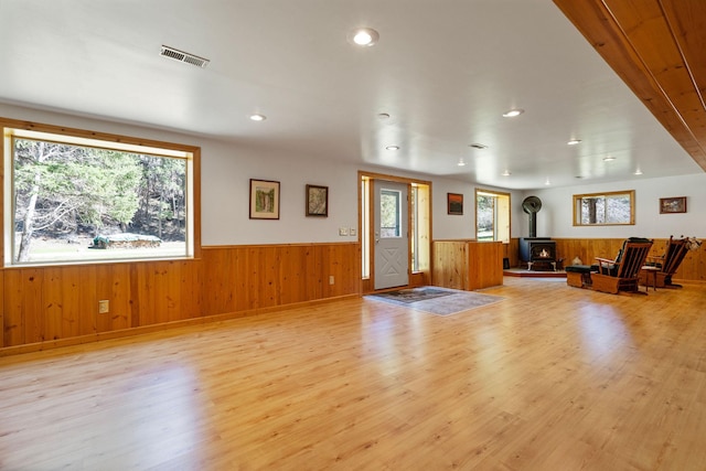 1000 Kelley Rd, Columbia Falls, MT 59912 - foyer featuring wainscoting, a wood stove, light wood-style flooring, wood walls, and recessed lighting