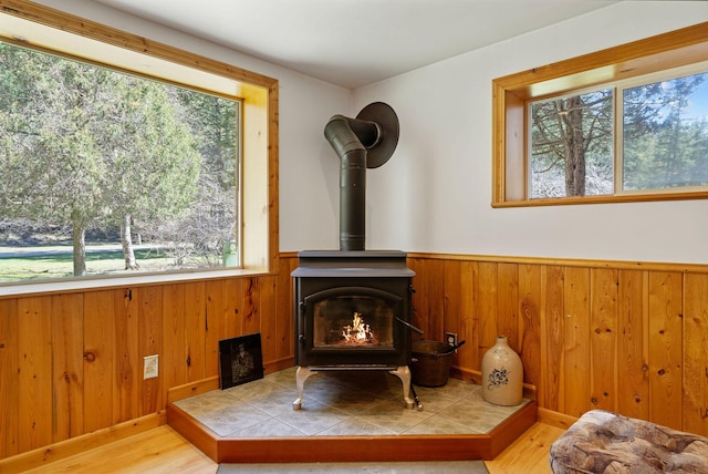 1000 Kelley Rd, Columbia Falls, MT 59912 - detailed view of a wood stove, wood finished floors, a wainscoted wall, and wooden walls