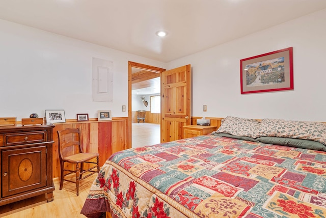 1000 Kelley Rd, Columbia Falls, MT 59912 - bedroom featuring a wainscoted wall, wood walls, light wood finished floors, and recessed lighting