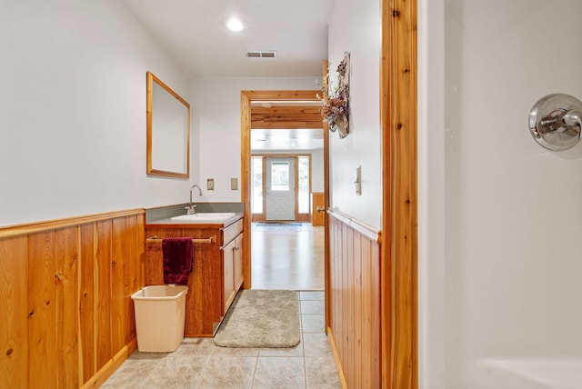 1000 Kelley Rd, Columbia Falls, MT 59912 - bathroom with wainscoting, vanity, wood walls, and tile patterned floors