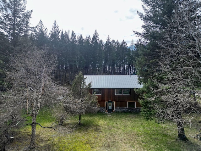 1000 Kelley Rd, Columbia Falls, MT 59912 - back of property featuring metal roof, a lawn, and a view of trees