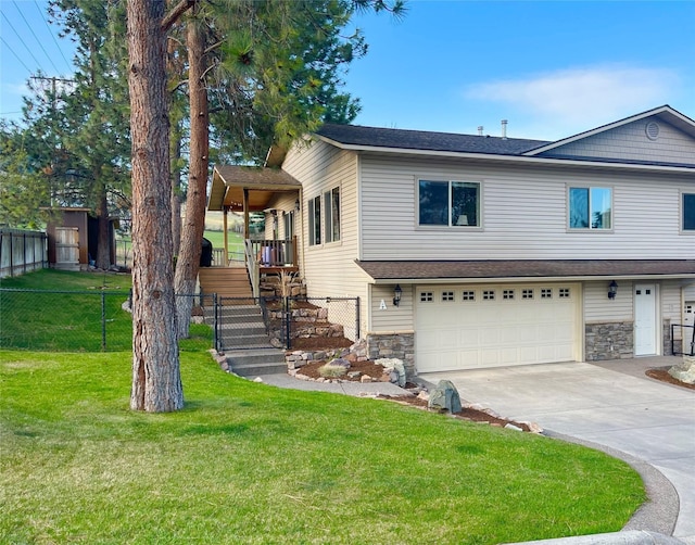 1023 Whitaker Dr Unit A, Missoula, MT 59803 - view of front facade featuring stairway, a garage, concrete driveway, and stone siding