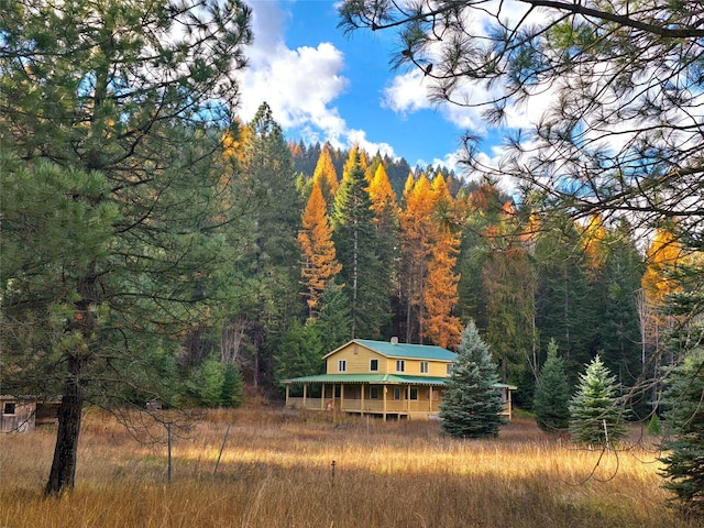 225 Marten Creek Rd, Trout Creek, MT 59874 - back of house featuring a forest view, a chimney, and a metal roof