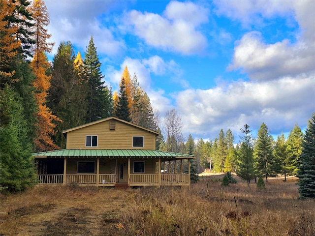 225 Marten Creek Rd, Trout Creek, MT 59874 - country-style home featuring a porch, a view of trees, and a metal roof