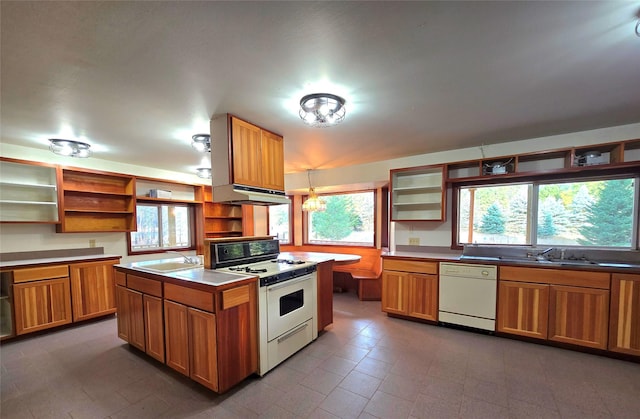 225 Marten Creek Rd, Trout Creek, MT 59874 - kitchen with white appliances, open shelves, under cabinet range hood, brown cabinetry, and decorative light fixtures