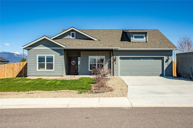 276 Tenderfoot Ln, Stevensville, MT 59870 - view of front facade featuring an attached garage, a shingled roof, and driveway